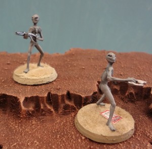 Grey Alien miniatures from Area 51 Miniatures perched atop a Martian mesa.