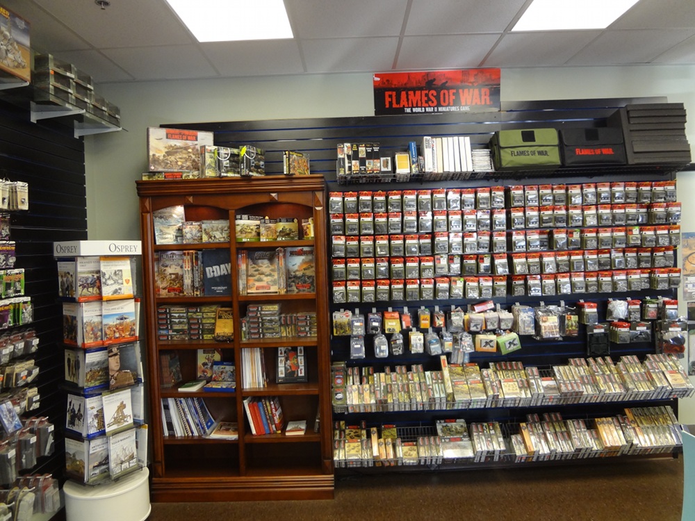 Little Shop of Magic's wall with a huge selection of Flames of War miniatures and rules.