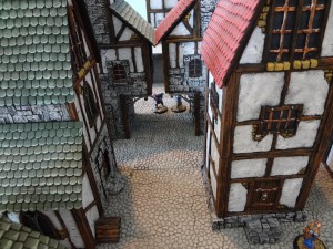 The view from a 2nd floor down a street lined with Custom Kingdoms buildings.