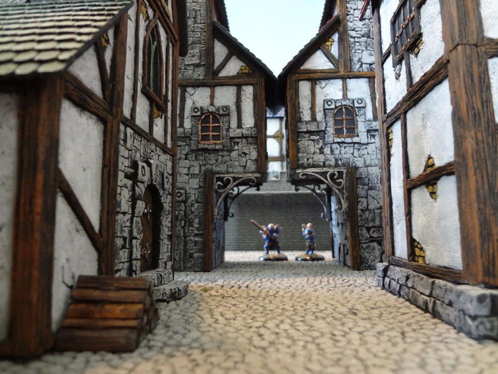 A view down a street lined with Custom Kingdoms miniature buildings.