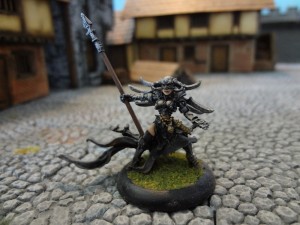 Cryx warwitch Deneghra stands atop Hirst Arts cobblestone streets
