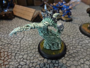 The pale and demonic Machine Wraith of Cryx with Storm Guard in the background