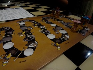 Lemming figurines start a race on the Mafia Lemmings game board at a bar