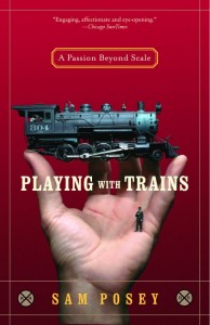Hand holding HO-scale figure and locomotive on cover of Playing with Trains by Sam Posey