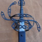 Steel sword showing pommel and intricate flowing hilt designed by David Baker