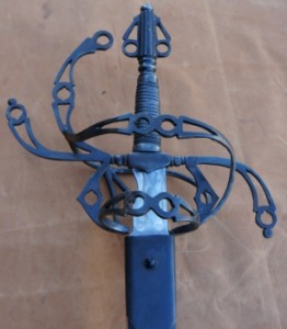 Steel sword showing pommel and intricate flowing hilt designed by David Baker