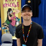 Kyle Stevens with Pac Man lanyard at Comic Con 2012 in the Kirby Krackle booth