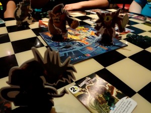 Kaiju monsters from Richard Garfield's King of Tokyo game battling over its game board, giant ape versus robot with mecha-dragon in foreground