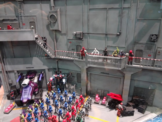 Diorama at the 2012 Hasbro booth at Comic-Con with GI Joe action figures lined up in a huge Cobra facility