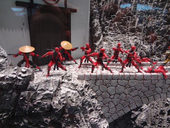 Red Ninja action figures from GI Joe by a building and bridge at the Hasbro Comic-Con 2012 booth