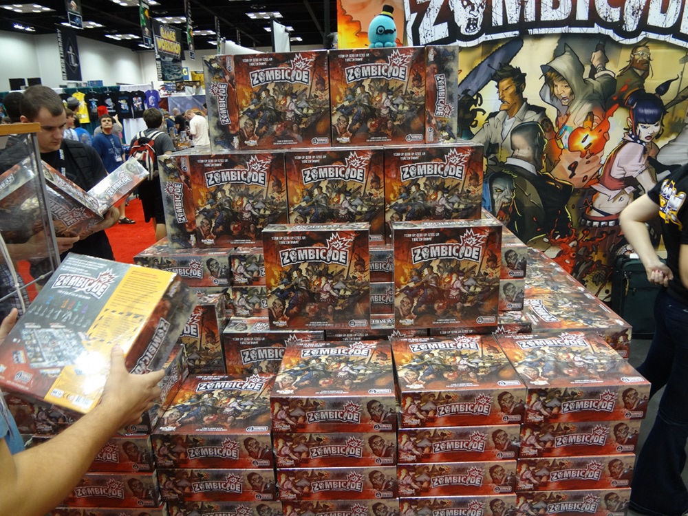 Boxes stacked head high at Cool Mini or Not's Gen Con Booth of Zombicide