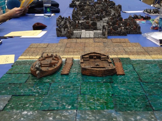 Hirst Arts dungeon for 25-28mm miniatures with miniature boats on water tiles at Gen Con