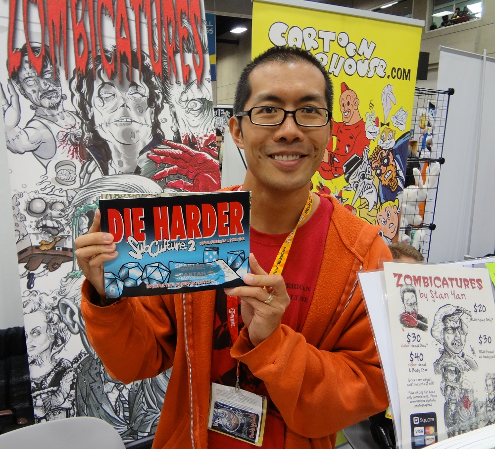 Stan Yan holds the printed version of Subculture at Comic-Con in 2012 in front of a zombie poster