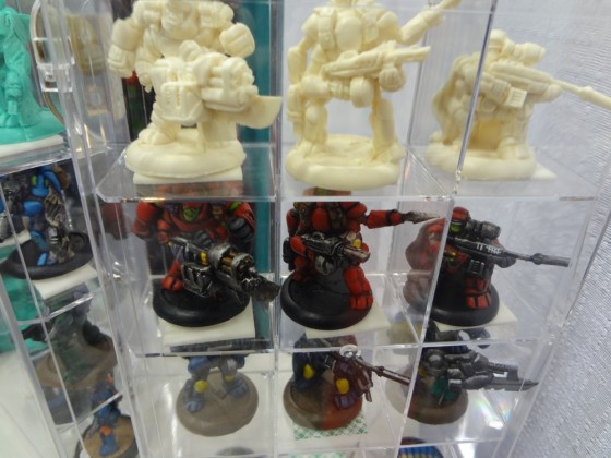 1:1 scale miniatures about 30mm tall in glass display case for Zynvaded game at Gen Con