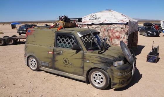 Scion coverted to military Wasteland Paint scheme with chain gun on roof at Wasteland Weekend