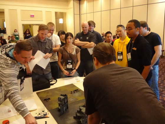 Retailers cluster around Games Workshop realm of battle board to learn Space Marine Paintball