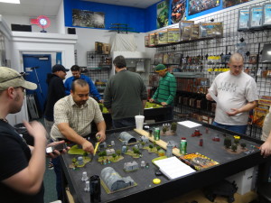 Heavy Gear Blitz players in a gaming shop playing a tournament