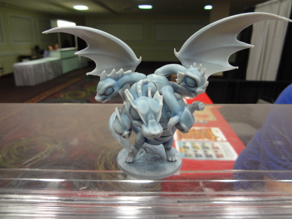 Five-headed plastic chibi Hydra with wings on display stand at GAMA Trade Show