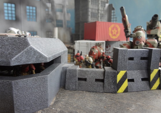Plastic AT-43 bunker reveals figures inside while others are hidden behind tall wall sections