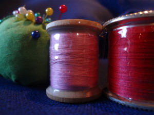 Spools of thread with Hugo's Amazing Tape wrapped around them keeping threads confined