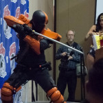 Deathstroke cosplayer brandishes sword on stage at Las Vegas Comic Expo