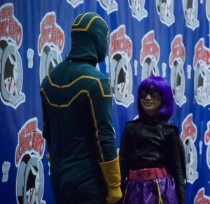 Kickass looks down at a grinning Hit Girl onstage at the Las Vegas Comic Expo's Cosplay Contest