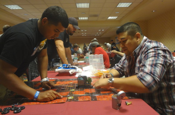 HeroClix players Justin Jimenez and Pat Yapojco face off with X-Men Team Bases in a tournament